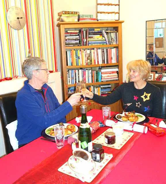 A traditional Christmas lunch in the UK: roast turkey crown with roast potatoes, stuffing, vegetables, bread sauce, pigs in blankets and served with champagne and crackers