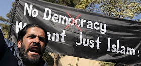 [Afghan+university+students+shout+anti-US+slogans+and+hold+a+banner+reading+'No+Democracy;+We+want+just+Islam!'+during+a+demonstration+in+Kabul+on+October+25,+.jpg]