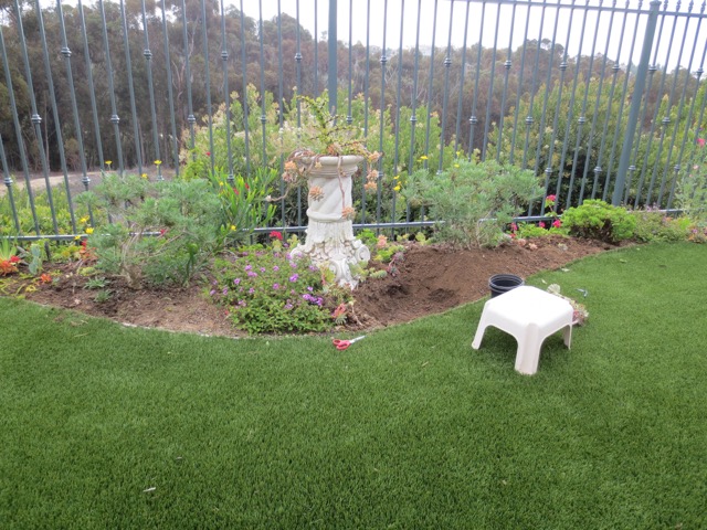 Preparing the soil by digging and getting it ready for the new plants.