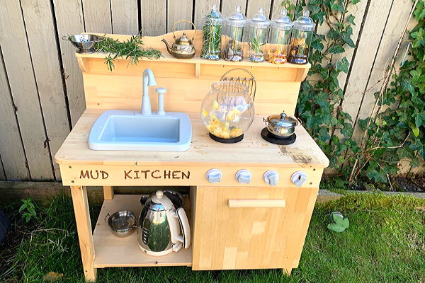 mud kitchen with working sink plastic jars and real teapot