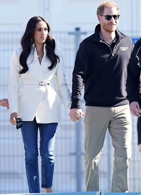 Meghan Markle wore a white belted jacket from Brandon Maxwell Fall-2022 collection. Prince Harry met athletes and organisers