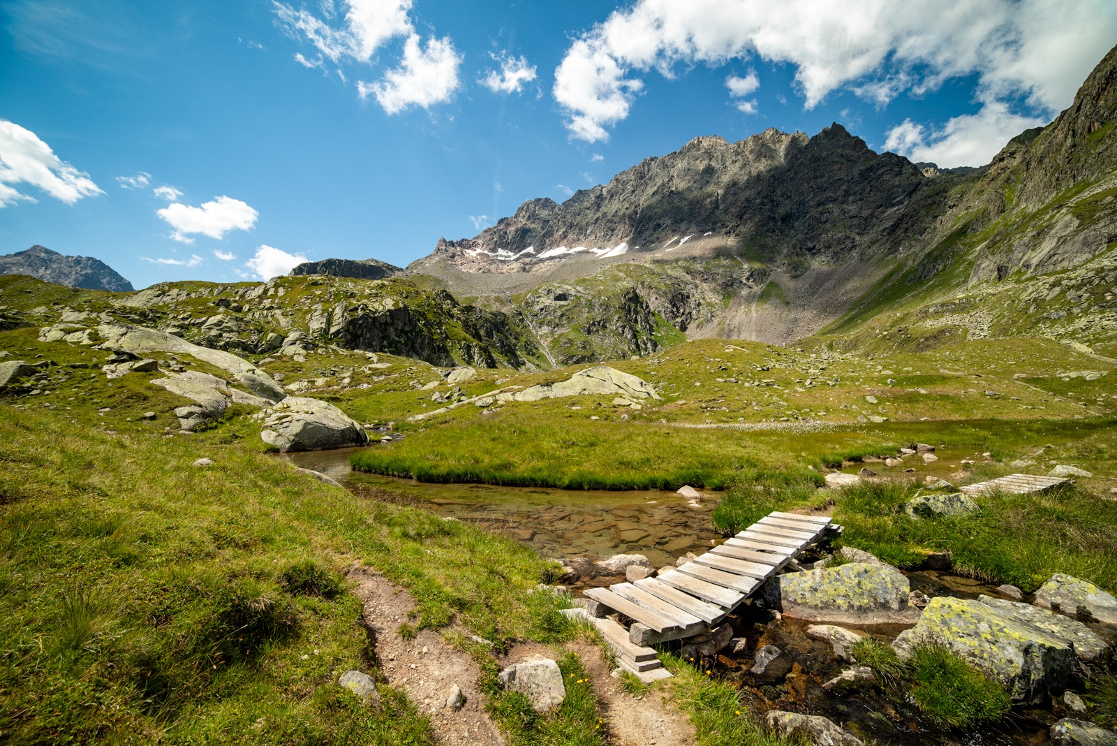 Alpejski szlak przez mokradła w pobliżu jeziora Mutterberger See w Alpach Sztubajskich. Stubaital.