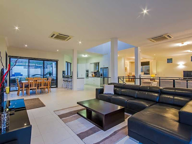 Picture of open living room with black leather couch 