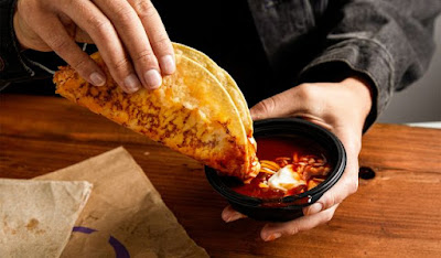 Taco Bell's Cheesy Enchilada Dipping Taco with dipping sauce.
