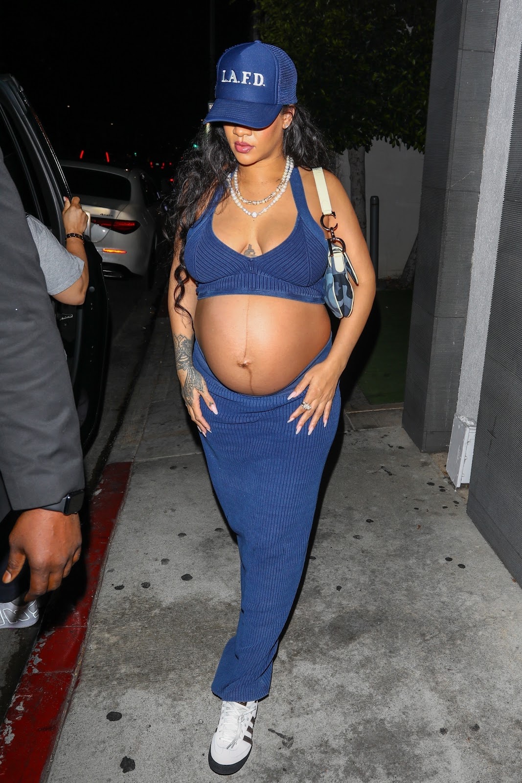 Rihanna shows off her BABY BUMP in bra top and skirt after dinner with ASAP Rocky at Nobu in Los Angeles.