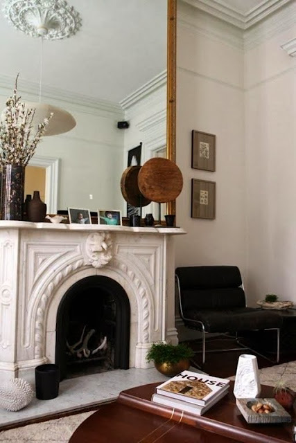 neutral living room oversized gold mirror fireplace accents neutral furniture