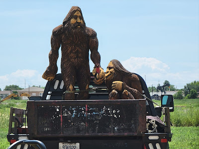 A male and female yeti hanging out in the back of a (real) pickup truck