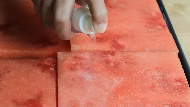 Spraying rosewater on watermelon for Watermelon and Strawberry Cake image