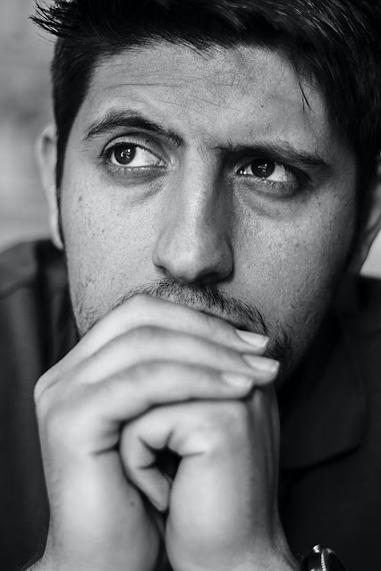 thoughtful-man-folding-hands-and-leaning-with-hand