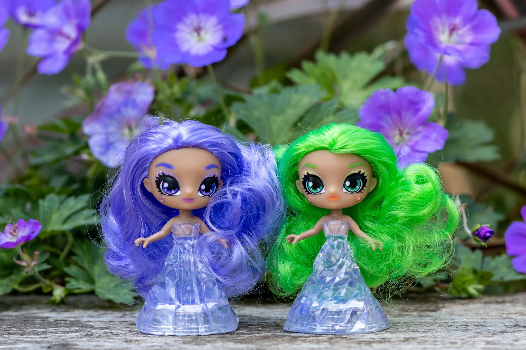 Purple haired amethyst and green haired adventurine crystalina sprite dolls next to each other