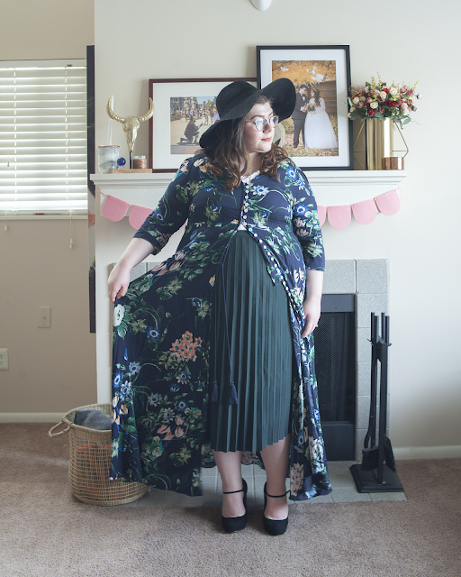 An outfit consisting of a cream bodice and white organza puffy princess sleeves crop top tucked into blue high waist denim jeans and dusty pink pointed toe mules