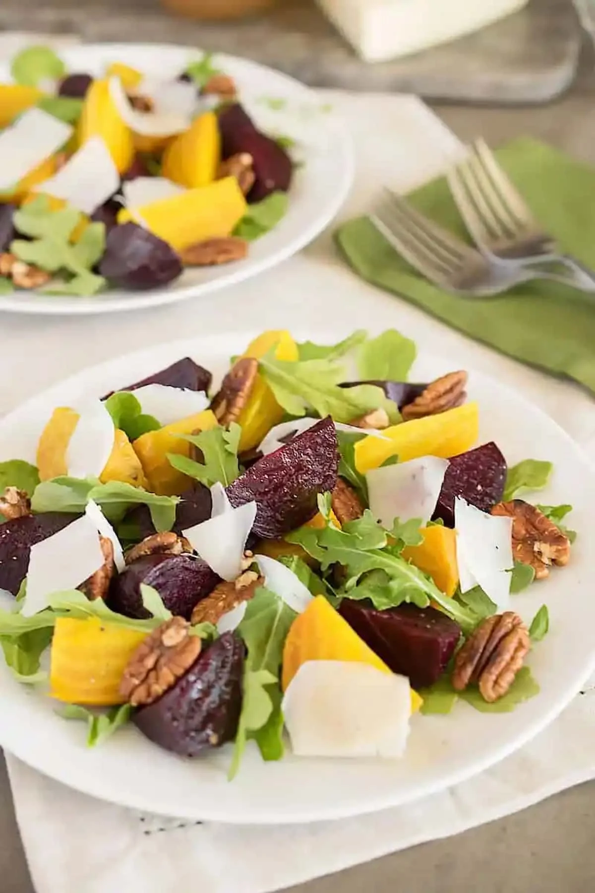 A side shot of 2 Roasted Beet Salads on a white plate.