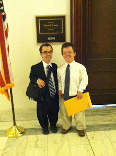 two men of short stature standing outside Senate Office Door