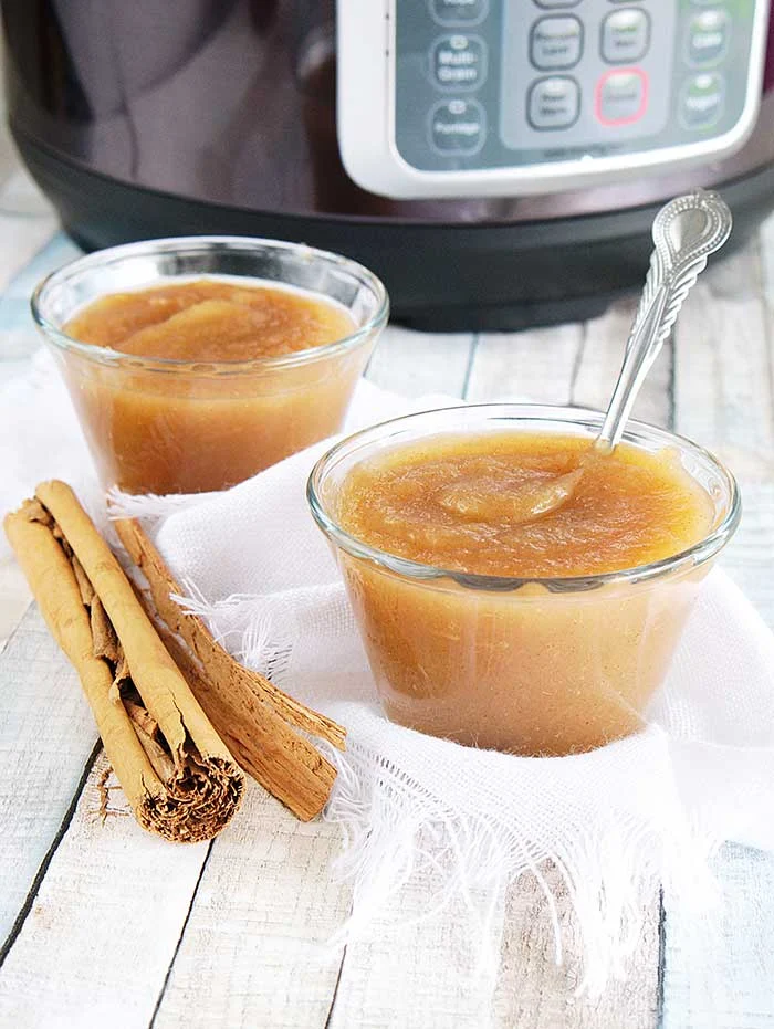 How to make applesauce in an Instant Pot. Use your Instapot to make homemade healthy applesauce with honey and cinnamon. This whole 30 no sugar recipe makes unsweetened applesauce or honey sweetened applesauce, your choice.  Make quick small batch apple sauce for baby or for adults.  You can then make canned applesauce or put it in the freezer to save for later. Freezing recipes is easier ofr his DIY home made recipes. Also gives tips for the best apples to use.  #instantpot #applesauce #apples 