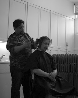 Volunteer cutting guest's hair at Welcome