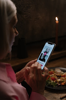 photo of a woman looking at a dating app on her phone.