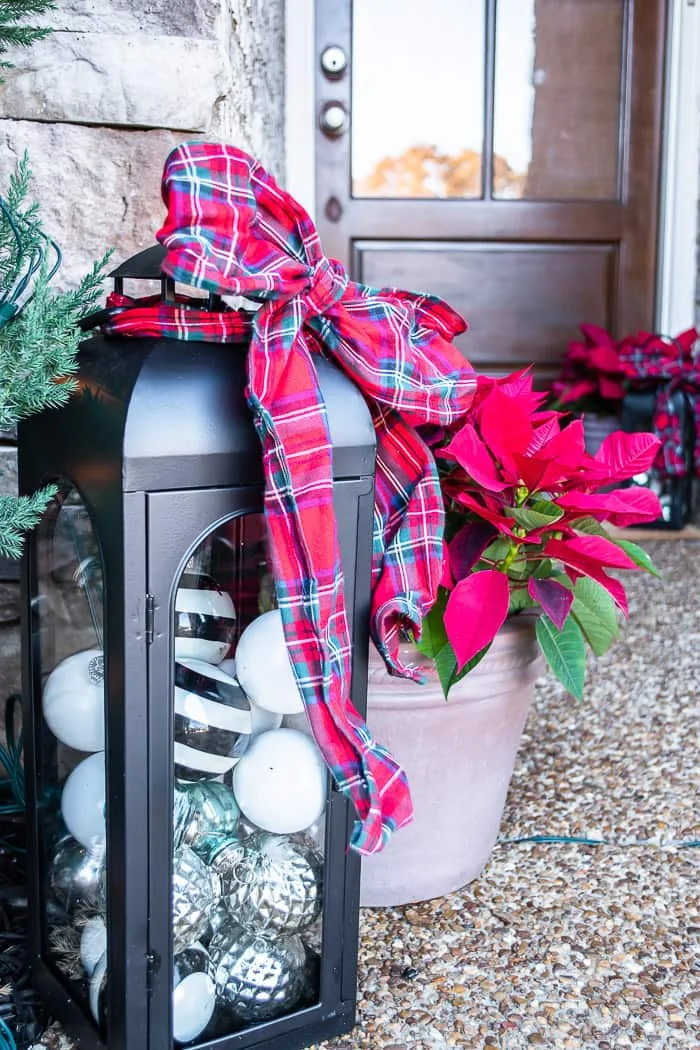 lanterns filled with ornaments, plaid ribbon bow