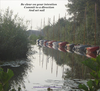 Image of coloured sail boats in a row on a river with the text Be Clear on your intention, commit to a direction, And set sail