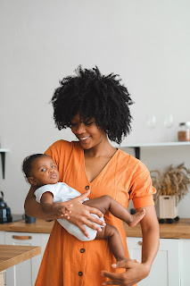 A mom in the kitchen with her baby in her arms