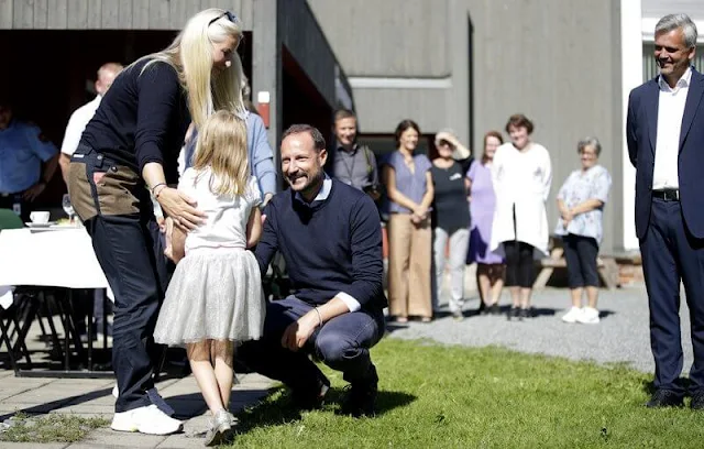 Crown Princess Mette-Marit wore a navy blue cashmere sweater. Fjallraven black and beige trekking trousers