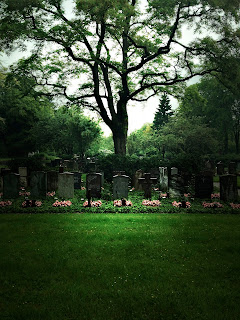 photographs of graves in a cemetery on a rainy day by andreas warren matti