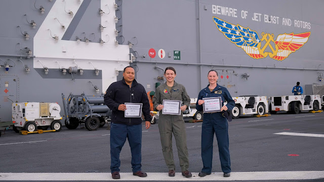 Photo By Petty Officer 1st Class Kelsey Eades | Lt. Shaun Williams, Lt. Marilyn Kimbrough and Ens. Danielle Cain, all serving aboard the amphibious assault ship USS Boxer (LHD 4), pose for a group photo on the flight deck after receiving their top selection for medical residency specialties in anesthesiology, pediatrics and family medicine, as the ship steams the Pacific Ocean, Dec. 19, 2023. The Boxer Amphibious Ready Group, comprised of Boxer, USS Somerset (LPD 25), and USS Harpers Ferry (LSD 49), and the embarked 15th Marine Expeditionary Unit are underway conducting integrated training and routine operations in U.S. 3rd Fleet. (U.S. Navy photo by Mass Communication Specialist 1st Class Kelsey J. Eades)