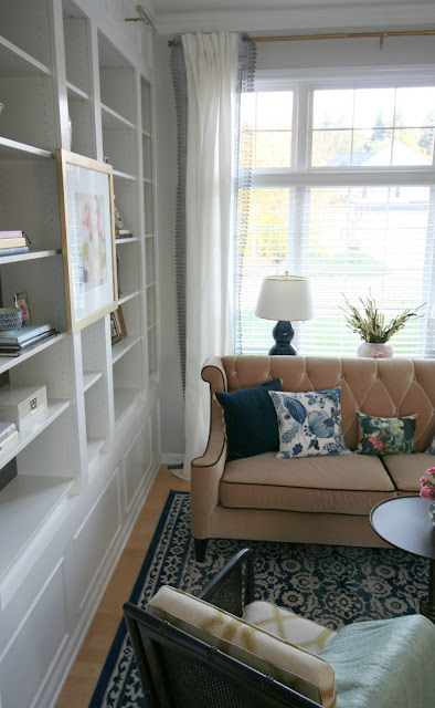 Living Room makeover with custom Ikea Billy bookcase built ins, blush velvet sofa, sherwin williams peppercorn on bookcase, sheriwin williams crushed ice on wall chic living room with picture lights