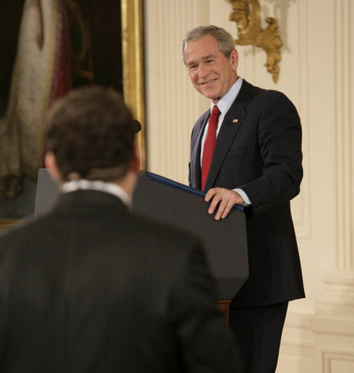 President George W. Bush smiles as he responds to a writer's question Wednesday, Feb. 14, 2007, during a press conference in the East Room of the White House. The President covered many topics including international issues and bipartisan opportunities. White House photo by Eric Draper.