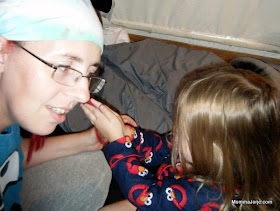 Toddler Sasha, learning to palm roll Momma Jorje's dreadlocks