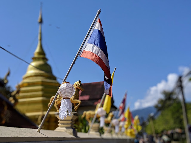 Thai flag and lanterns outside a wat in Chiang Mai, Thailand