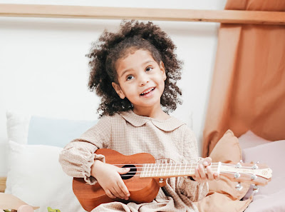 Girl holding an 'ukulele