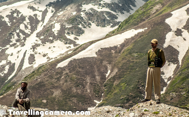 Few weeks back I was in Kashmir for Mughal Rally and second day was spent around Sinthan Pass. This Photo Journey shares some of the photographs from Sinthan Pass in Jammu & Kashmir State of India...Very first photograph of this Photo Journey is showing a huge flock of sheeps passing through snow at Sinthan Pass.Here is a photographer who was there with us for covering 3rd Mughal Rally in Jammu & Kashmir - Varun, a great photographer and good company. All these regions around Sinthan pass are quite safe and army folks can be seen all around these hills. During Mughal Rally, security was increased and these two folks were around us for most of the time when we were busy in shooting various SUVs, Gypsys, Cars & Bikes etc. btw, in above photograph you don't see other security personnel. These folks rock whole make all residents of Kashmir safe by putting their best efforts throughout the year. Things are getting better and hope to improve multi-fold in future.The Sinthan Pass is at 12.5K feets and ignored as one of the barren passes until a few years ago... Sinthan Pass is now quite popular because of wonderful connectivity although some patches are under process, but one can drive from Srinagar to Sinthan Pass. It's an enjoyable ride, at least near Sinthan Pass.  Travellers have to cover 290 km to reach Kishtwar via the Srinagar-Jammu highway and the Srinagar-Sinthan-Kishtwar road reduces the distance by 200 km, which is amazing...Distances to various places from Sinthan Pass are - Chingam - 41 KmKishtwar - 83KMDoda - 143 KmBatote - 193KMJammu - 315 KMSame information can be seen on the board you see in above photograph at Sinthan Pass in Jammu & Kashmir State of IndiaThis photograph was shot in the foothill of Sinthan Pass. It was a beautiful village with green fields all around. Girl walking trough these paddy fields was something that I thought of shooting with by Travelling-CameraHere is a photograph of Kashmiri folks sitting on edge to enjoy Mughal Rally in these curved roads around Sinthan Pass. This valley was 10X deep, what you see here. This man in photograph was good company for me at the point where I wanted to shoot moving cars against snow covered peaks. He was here with his sheep...There are various water streams around Sinthan Pass. The water of these springs is the purest and digestive. There was a proposal to export the water of this spring in bottles to other parts of the country. Of course, some treatment may be required for bottling purpose. Locals here are against construction of concrete structures but they feel the need to develop this place as an eco-friendly tourism destination to regain its glory as it has chain of tourist spots from Achabal to Daksum to Sinthan Top. Besides, Kokernag is also connected to Verinag, another scenic resort known also for the springs and origin of Jehlum River via link road...