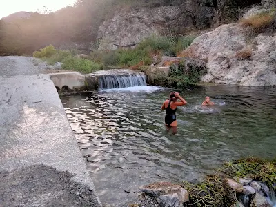 Murielle and the child Hope bathe in the river