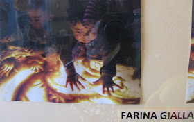 photo of: Reggio Emilia children explore sensory materials on light table
