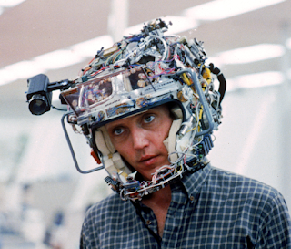 Christopher Walken's character, Michael Brace, pictured with a contraption on his head developed for recording and playing back the actual experiences of people.