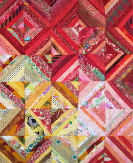 Quilt blocks composed of strips of red fabric or yellow fabric.