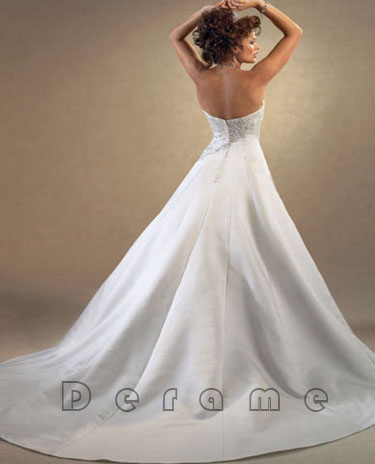 Spaghetti line white wedding gown full with embroidery pattern in front of
