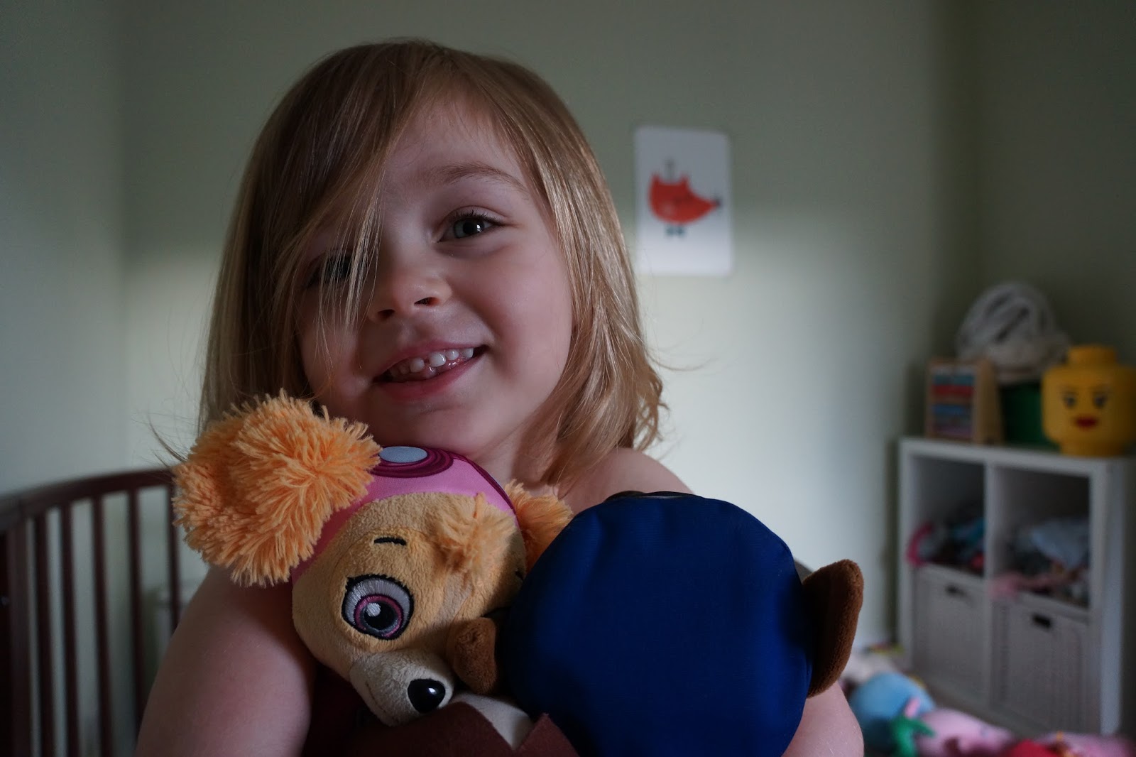little girl smiling and holding teddies - how my kid tries to avoid sleeping