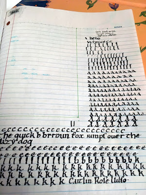 A sheet of college-ruled notebook paper, with a rectangle marked filling the upper left quarter of the page, and thick black pen letters filling the rest of the space. The practice letters start as vertical lines, then progress to several lines of lowercase ays, a few of uppercase ays, one line of cees, a single copy of "the quick brown fox jumps over the lazy dog," with a few misshapen letters repeated, and then a few lines of ees, bees, and kays.