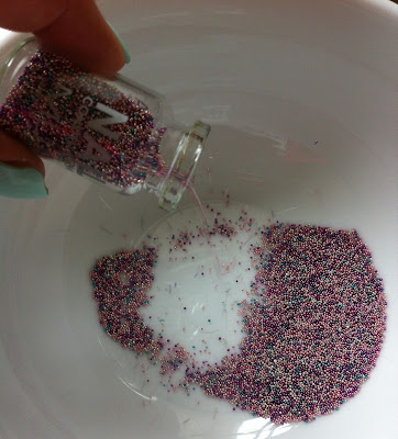 Beads being poured into bowl