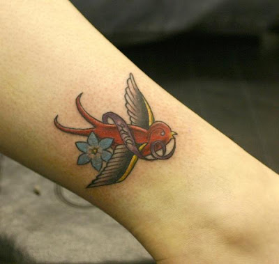 flying small bird tattoo
