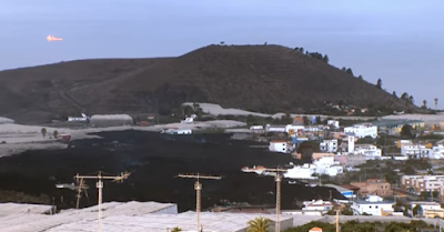 Lava flow encroaching on a suburb