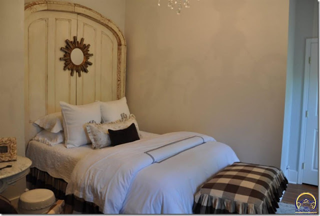 bedroom with white bedding and old door headboard house for sale in melvern kansas