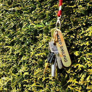 Keys with a 'keep smiling' key chain