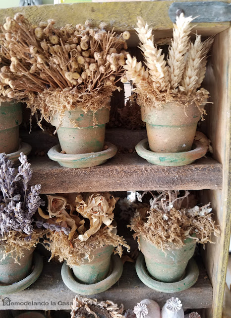 dried flower arrangement in soda crate