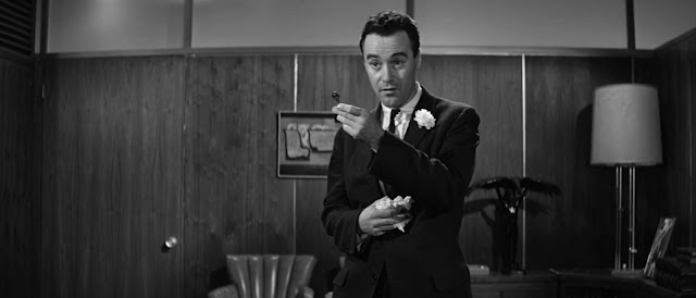 C. C. Baxter (Jack Lemmon) offers up the key to his apartment.