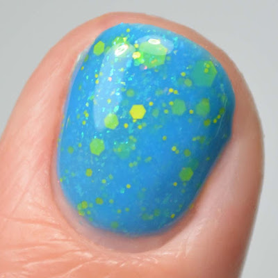 bright blue glitter nail polish close up swatch