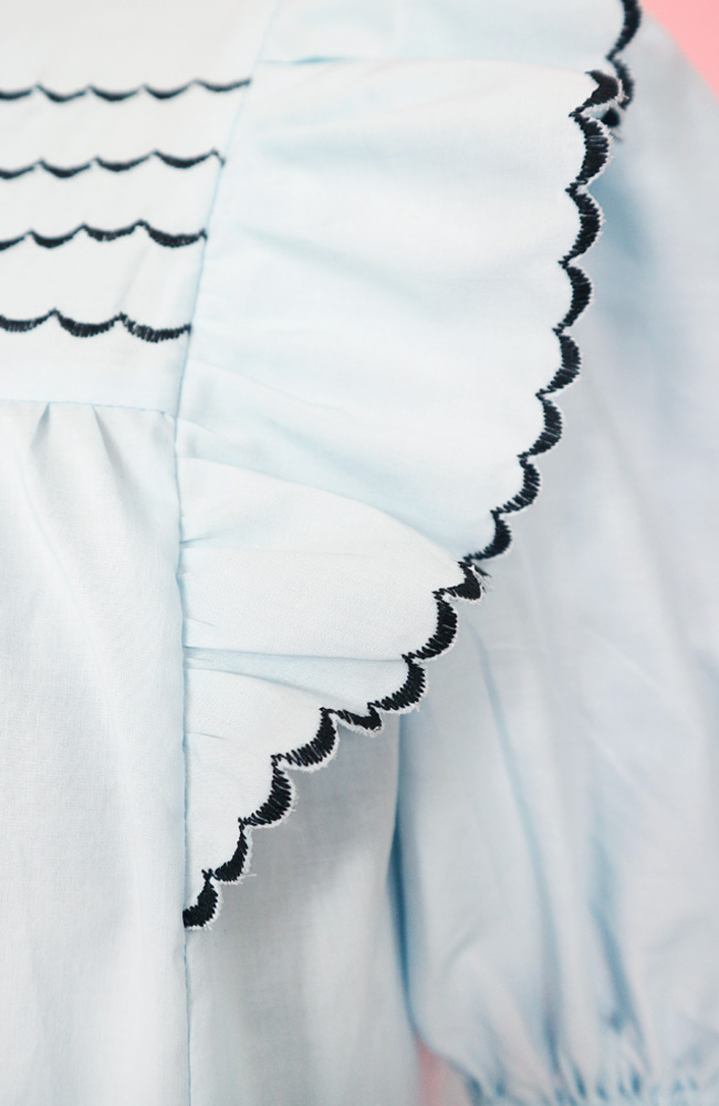 A close up of the scallop edge stitch on a finished Marnie blouse with shoulder ruffles.