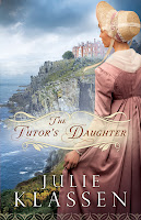 cover of The Tutor’s Daughter by Julie Klassen shows woman in pinkish dress standing on a cliff overlooking the sea