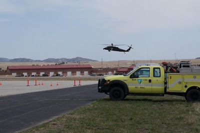 A BLM engine waits for a military helicopter to land before navigating the Evasive Driving Course. 